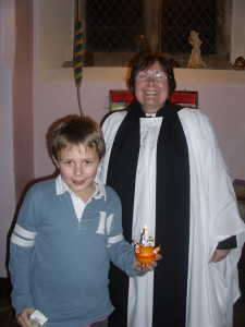 Pictured with his finished Christingle is Oliver Baggott (age 9) with Rev'd Fliss Iliffe. 