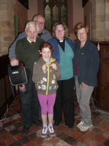 Pictured are FRONT - Lydia Baggott (8) with her Brownie "Good Deed" badge MIDDLE - Mr George Poyner, Rev'd Val Smith and Mrs Mary Nelson BACK - Paul Stedman 
